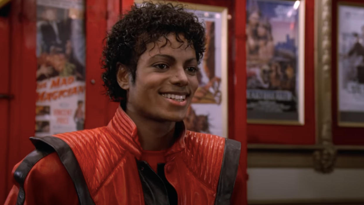  Michael Jackson smiling in a movie theater lobby in Thriller. 