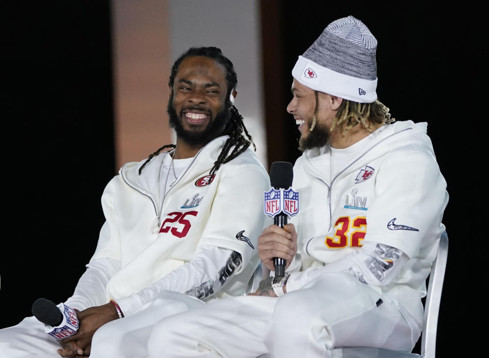 San Francisco 49ers' Richard Sherman, left, and Kansas City Chiefs' Tyrann Mathieu chat during Opening Night for the NFL Super Bowl 54 football game Monday, Jan. 27, 2020, at Marlins Park in Miami. (AP Photo/David J. Phillip)