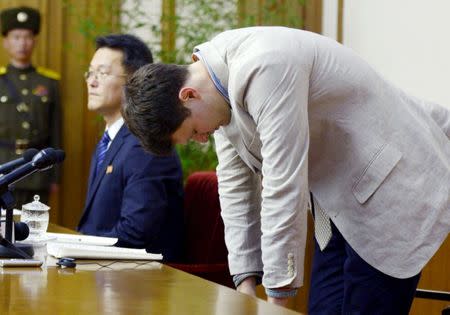 FILE PHOTO: Otto Frederick Warmbier (R), a University of Virginia student who has been detained in North Korea since early January, bows during a news conference in Pyongyang, North Korea, in this photo released by Kyodo February 29, 2016. Mandatory credit REUTERS/Kyodo/File Photo