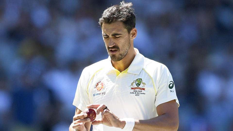 Mitchell Starc holding the Kookaburra before he bowls.