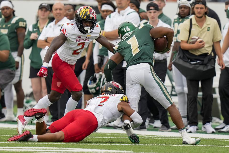 Sep 10, 2022; Charlotte, North Carolina, USA; Maryland Terrapins defensive back Dante Trader Jr. (12) tackles Charlotte 49ers wide receiver Victor Tucker (1) along with defensive back Jakorian Bennett (2) during the second half at Jerry Richardson Stadium. Mandatory Credit: Jim Dedmon-USA TODAY Sports