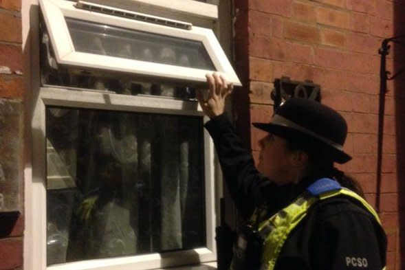 A Coventry PCSO checking an open window.