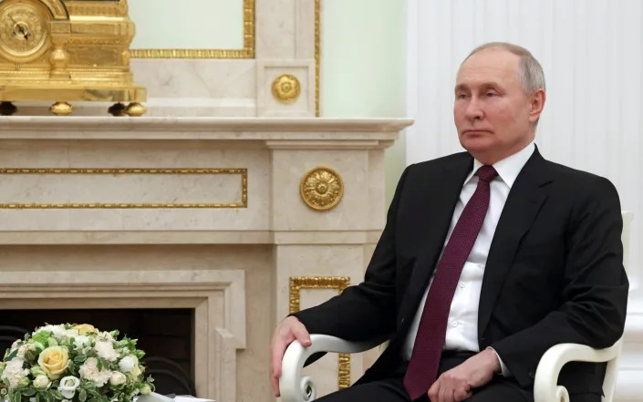 Russian President Vladimir Putin listens to Chinese President Xi Jinping during their meeting at the Kremlin in Moscow, Russia