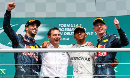 Germany Formula One - F1 - German Grand Prix 2016 - Hockenheimring, Germany - 31/7/16 - Red Bull Racing's Daniel Ricciardo (L) and Max Verstappen (R) pose with Mercedes' Lewis Hamilton after the race. REUTERS/Ralph Orlowski