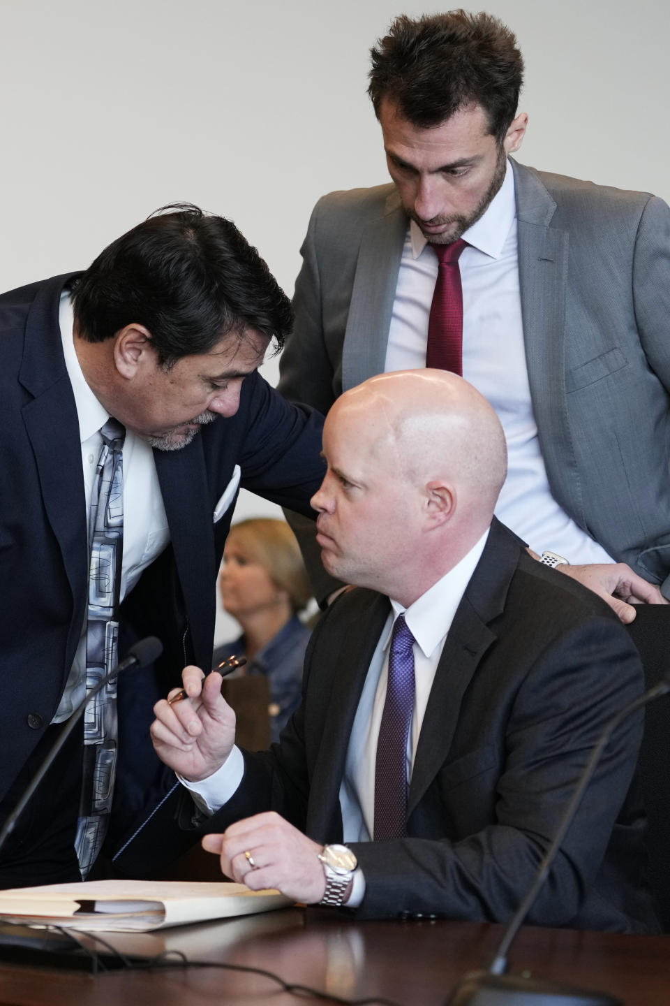 Robert E. Crimo III's attorney Gregory Ticsay, left, speaks to Ben Dillon of Lake County Assistant State's Attorney as Anton Trizna of an assistant public defender at Lake County, top, listens before Judge Victoria A. Rossetti arrives at the Lake County Courthouse Monday, Dec. 11, 2023, in Waukegan, Ill. Robert Crimo III, accused of killing seven and wounding dozens more at a Fourth of July parade in 2022, asked a Lake County judge to allow him to continue without the aid of his assistant public defenders and invoked his right to a speedy trial. (AP Photo/Nam Y. Huh, Pool)