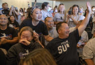 St. Paul Olympian Sunisa Lee's parents Yeev Thoj, left, and John Lee and other family and friends react as they watch Sunisa Lee clinch the gold medal in the women's Olympic gymnastics all-around at the Tokyo Olympics Thursday, July 29, 2021 in Oakdale, Minn. (Elizabeth Flores/Star Tribune via AP)