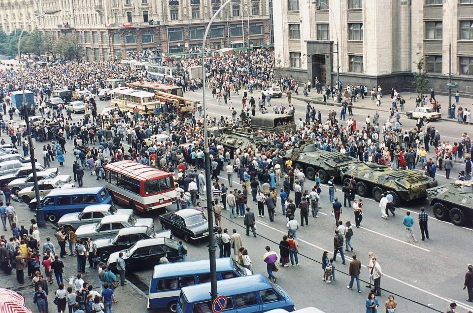 FILE - In this Monday, Aug. 19, 1991 file photo, Soviet tanks are surrounded by anti-coup demonstrators in an attempt to prevent them from moving into Moscow's Red Square, Russia. When a group of top Communist officials ousted Soviet leader Mikhail Gorbachev 30 years ago and flooded Moscow with tanks, the world held its breath, fearing a rollback on liberal reforms and a return to the Cold War confrontation. But the August 1991 coup collapsed in just three days, precipitating the breakup of the Soviet Union that plotters said they were trying to prevent. (AP Photo/Boris Yurchenko, File)