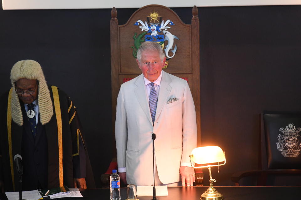 HONIARA, GUADALCANAL ISLAND, SOLOMON ISLANDS - NOVEMBER 25:  Speaker of the National Parliament of Solomon Islands John Patteson Oti (L) listens as Prince Charles, Prince of Wales address the National Parliament of the Solomon Islands at Parliament House during day three of the royal visit to the Solomon Islands on November 25, 2019 in Honiara, Guadalcanal Island, Solomon Islands. The Prince of Wales and Duchess of Cornwall just finished a tour of New Zealand. It was their third joint visit to New Zealand and first in four years. The Prince is currently on a solo three day tour of The Solomon Islands. (Photo by  Victoria Jones - Pool/Getty Images)