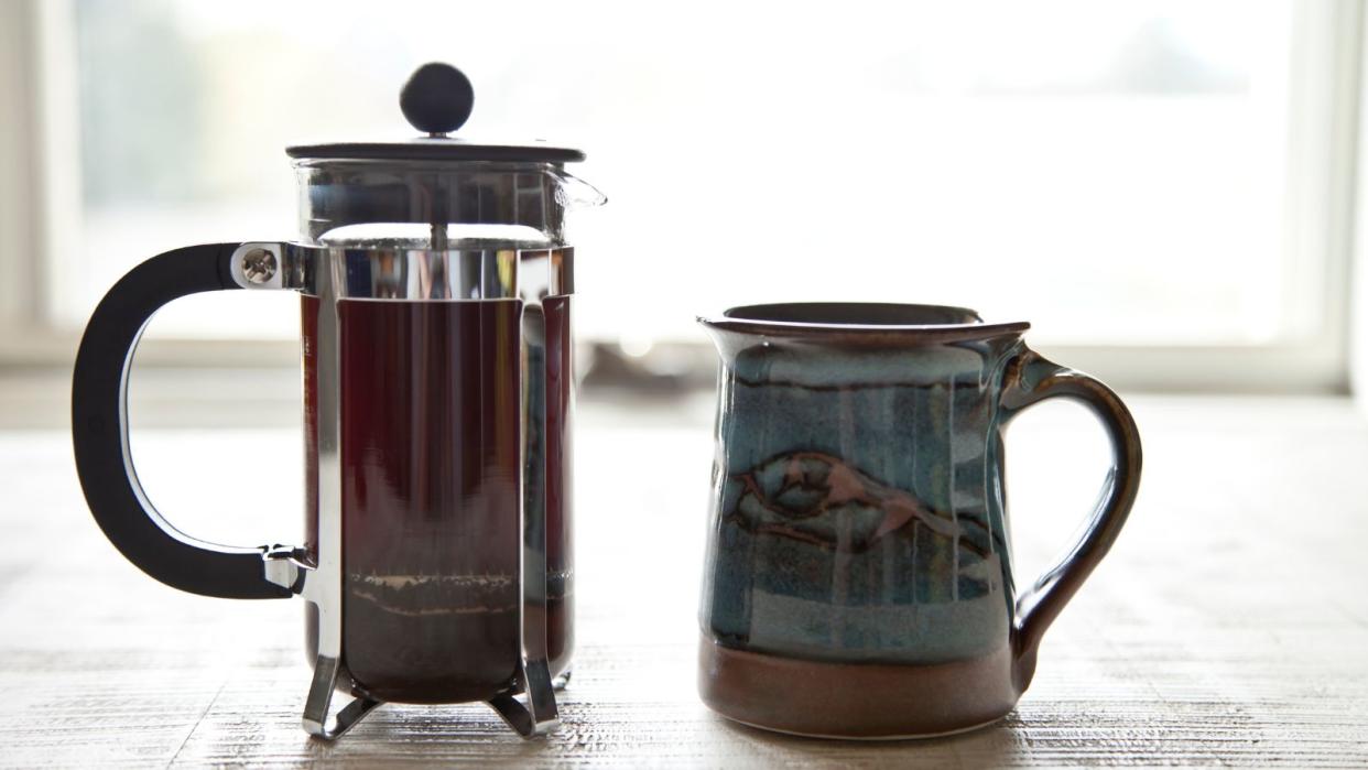  How to use a French press for more than coffee: a french press beside a mug of coffee 