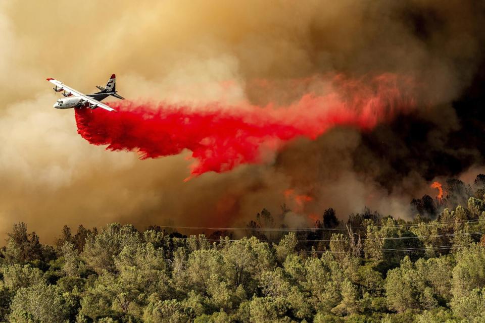 An air tanker drops retardant while battling the Thompson fire in Oroville.