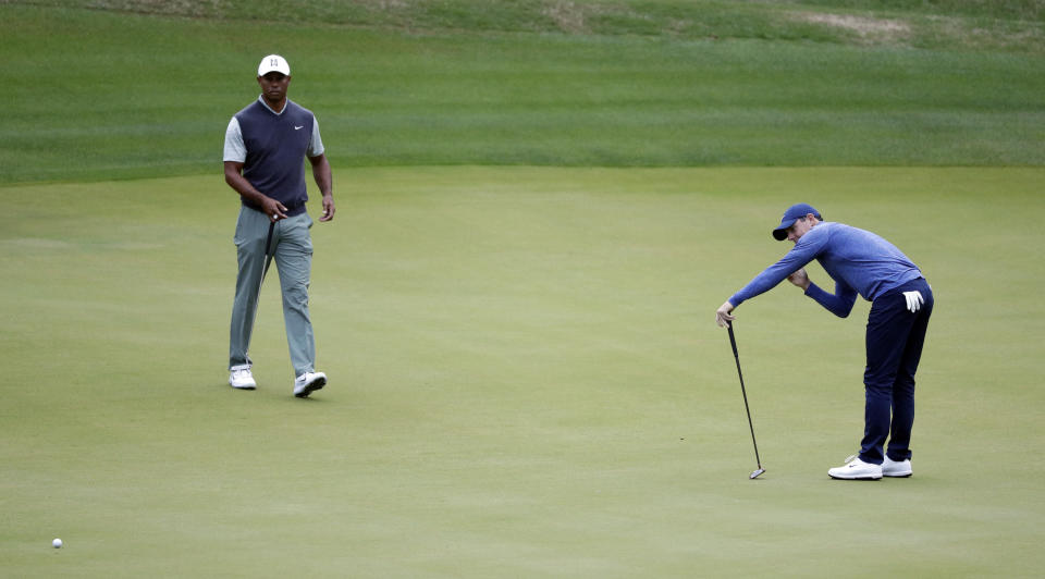 Rory McIlroy, right, reacts to missing a putt on the third hole as Tiger Woods, left, looks on during fourth round play at the Dell Technologies Match Play Championship golf tournament, Saturday, March 30, 2019, in Austin, Texas. (AP Photo/Eric Gay)