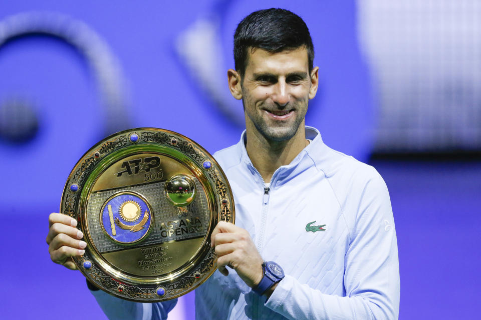 Serbia's Novak Djokovic poses with the trophy after winning the final tennis match of the ATP 500 Astana Open tennis tournament against Stefanos Tsitsipas of Greece in Astana, Kazakhstan, Sunday, Oct. 9, 2022. (AP Photo/Stas Filippov)