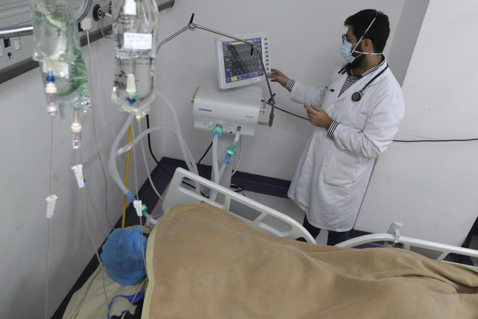 A medical staffer checks the data of a COVID-19 patient on a screen at the intensive care unit of the Rafik Hariri University Hospital in Beirut, Lebanon, Friday, Jan. 22, 2021. Hospitals in Lebanon are reaching full capacity amid a dramatic surge in coronavirus cases across the crisis-hit Mediterranean nation even amid strict lockdown. (AP Photo/Bilal Hussein)