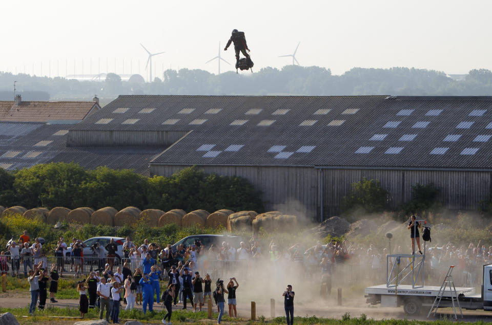 Franky Zapata, a 40-year-old inventor, takes to the air in Sangatte, Northern France, at the start of his attempt to cross the channel from France to England Thursday July 25, 2019. Zapata is anchored to his flyboard, a small flying platform he invented, taking off from Sangatte, in France's Pas de Calais region, and flying to the Dover area in southeast England. (AP Photo/Michel Spingler)