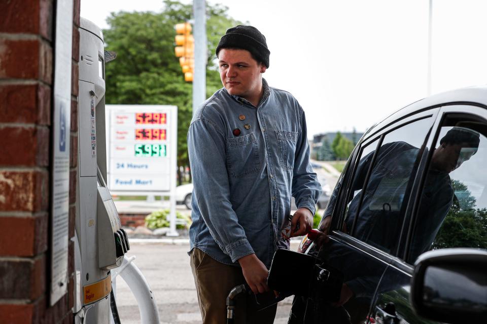 Brendan Ripper, a University of Michigan student pumps gasoline at a Shell gas station on Washtenaw Avenue in Ann Arbor on June 8, 2022.