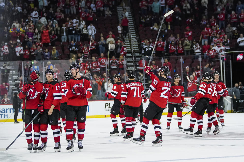 New Jersey Devils celebrate after defeating the Columbus Blue Jackets in an NHL hockey game, Sunday, Oct. 30, 2022, in Newark, N.J. (AP Photo/Eduardo Munoz Alvarez)