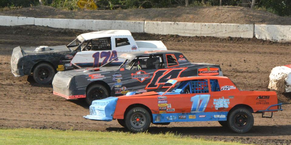 Jacob Aarhus of Canby, Minn. (17A), Maria Broksieck of Goodwin (14) and Matt Goth of Huron (17) battle for position during a street stock heat race at Casino Speedway on Sunday, July 16, 2023. Broksieck later won the street stock feature.