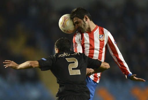 Atletico Madrid's forward Adrian Lopez (R) vies with Academica's defender Joao Dias during the UEFA Europa League football match A. Academica de Coimbra vs Club Atletico de Madrid at the Cidade de Coimbra stadium in Coimbra. Academica won 2-0