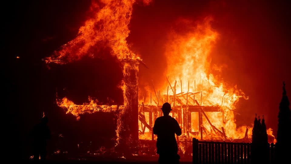 A home burns as the Camp Fire rages through Paradise. - Noah Berger/AP