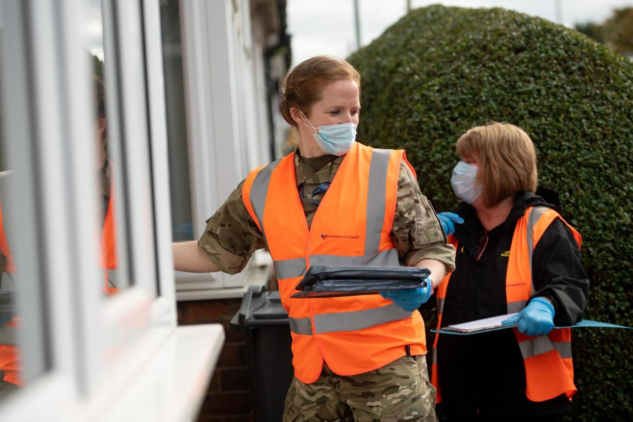 RAF personnel in Selly Oak, close to the University of Birmingham, assisting with Birmingham City Council's 'Drop and Collect' coronavirus test distribution on Tuesday: PA