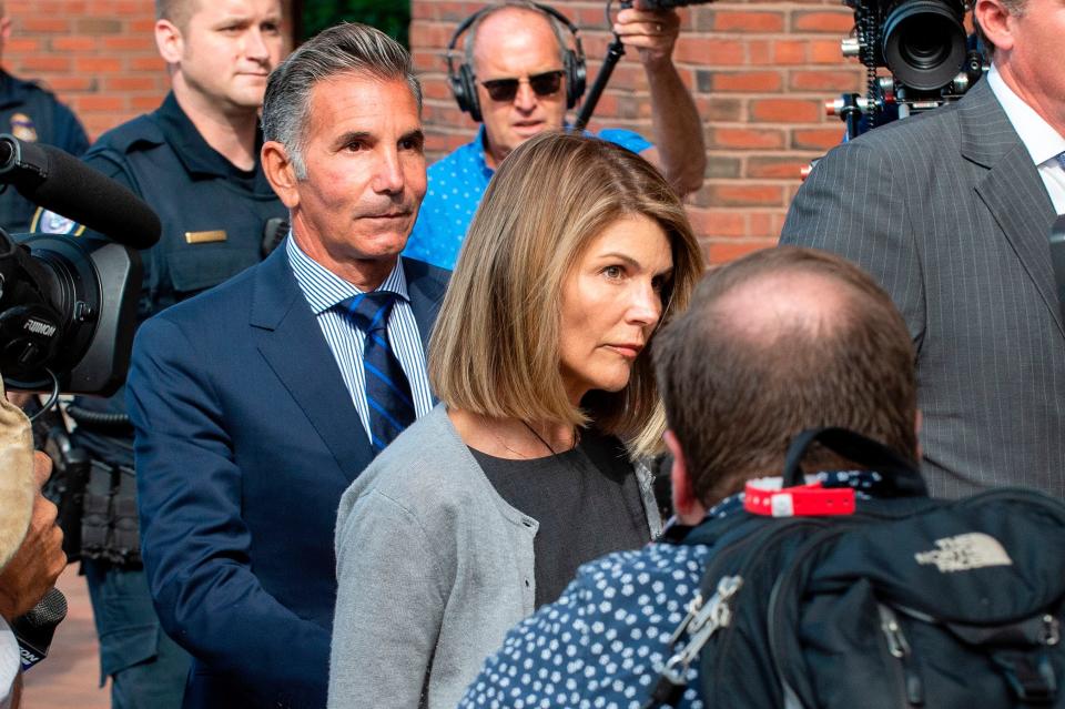 Lori Loughlin and husband Mossimo Giannulli exit the federal courthouse in Boston on Aug. 27, 2019.