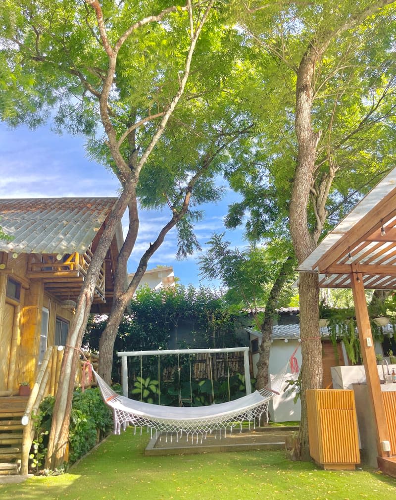 Hammock struck between two trees in yard.