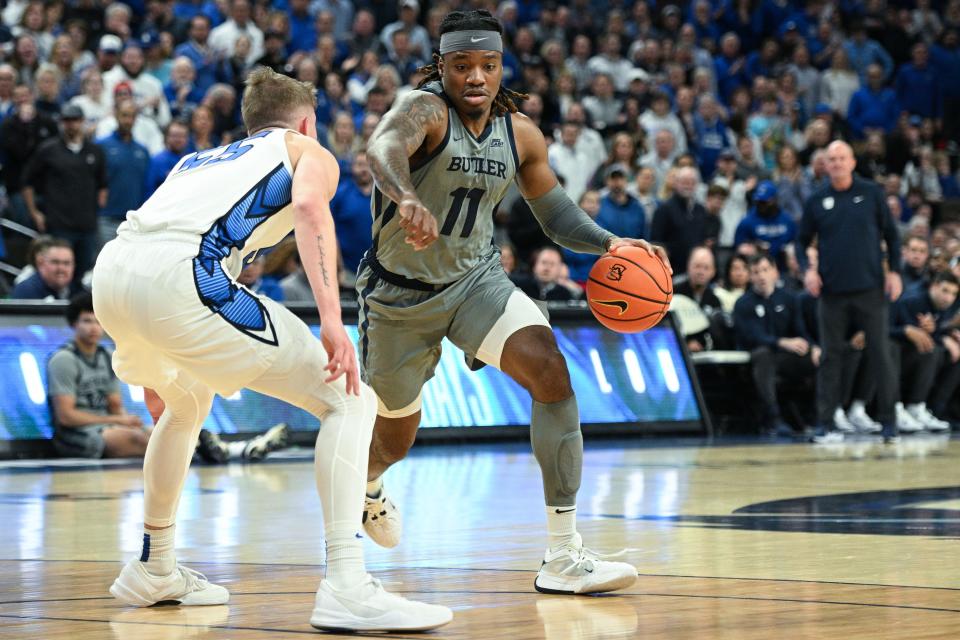 Feb 2, 2024; Omaha, Nebraska, USA; Butler Bulldogs guard Jahmyl Telfort (11) drives against Creighton Bluejays guard Baylor Scheierman (55) in the first half at CHI Health Center Omaha. Mandatory Credit: Steven Branscombe-USA TODAY Sports