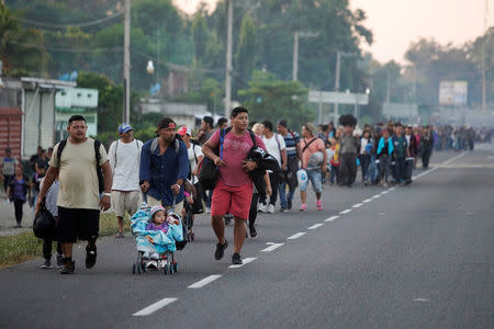 Migrants walk during their journey towards the United States, in the outskirts of Ciudad Hidalgo, Mexico, January 18, 2019. REUTERS/Alexandre Meneghini