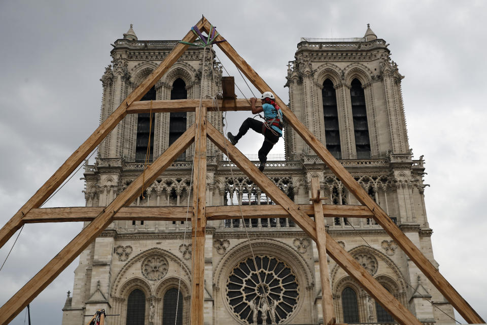 FILE - Charles, one of the carpenters puts the skills of their medieval colleagues on show on the plaza in front of Notre Dame Cathedral in Paris, France, Saturday, Sept. 19, 2020. The restoration of Notre Dame hits a milestone Friday, Dec. 8, 2023: one year until the cathedral reopens its huge doors to the public. (AP Photo/Francois Mori, File)