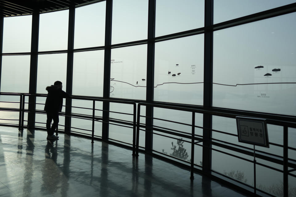 A visitor looks at the North Korean side from the unification observatory, in Paju, South Korea, Friday, Jan. 5, 2024. North Korea fired artillery rounds Friday near its disputed sea boundary with South Korea in violation of a fragile 2018 military agreement, officials said, prompting the South to plan similar drills. (AP Photo/Lee Jin-man)