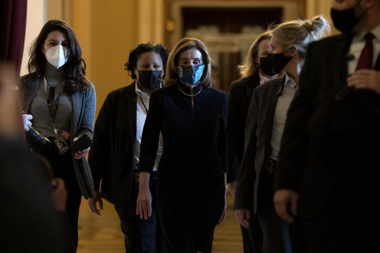 WASHINGTON, DC - JANUARY 13: Speaker of the House Nancy Pelosi (D-CA) (C), surrounded by a security detail, walks to her office from the House Floor at the U.S. Capitol on January 13, 2021 in Washington, DC. The House of Representatives is expected to vote to impeach President Donald Trump later today, after Vice President Mike Pence declined to use the 25th amendment to remove him from office after protestors breached the U.S. Capitol last week. (Photo by Stefani Reynolds/Getty Images)