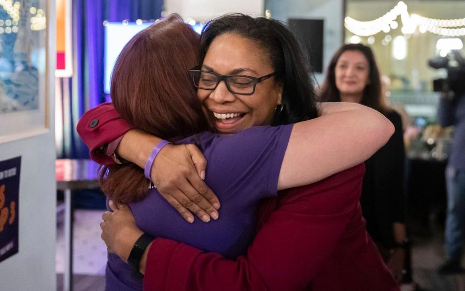 Two women hug as they celebrate the result of the Michigan abortion rights vote - Ryan Sun/Ann Arbor News 