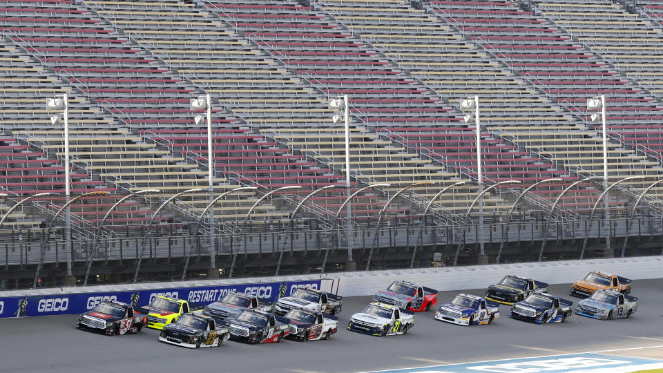 Pole sitter Chandler Smith (51) leads the field to the start of a NASCAR Truck Series auto race at Michigan International Speedway in Brooklyn, Mich., Friday, Aug. 7, 2020. (AP Photo/Paul Sancya)