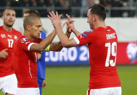 Switzerland's Goekhan Inler (L) celebrates his goal with team mate Josip Drmic during their Euro 2016 Group E qualifying soccer match against San Marino in St. Gallen, Switzerland October 9, 2015. REUTERS/Arnd Wiegmann