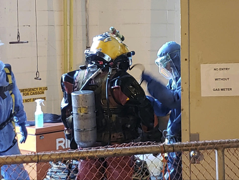 This photo provided by Charleston Water System on Saturday, Oct. 20, 2018, shows divers getting ready to deep dive into the sewer, to pull out huge balls of oily, black used wet wipes and baby wipes that had clogged intake pumps in Charleston, S.C. The system had to send in the divers nearly 100 feet (30 meters) into a sewer well after the wipes, congealed by grease and other items sent into the pipes, clogged the suction intake pumps to the Plum Island Wastewater Treatment Center on James Island. (Charleston Water System via AP)