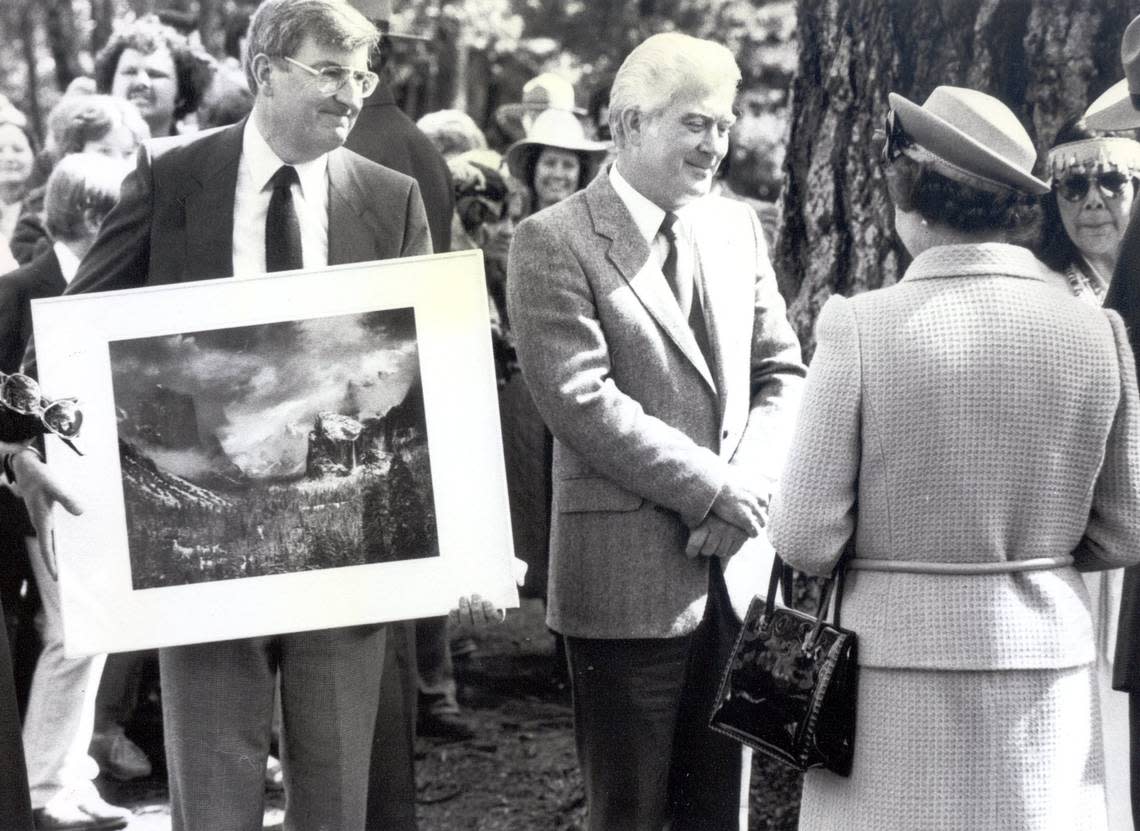 During her 1983 visit to Yosemite National Park, Queen Elizabeth II meets with Dr. Michael Adams, left, who presented her with a print by his father, Ansel Adams, and carver Rocky Reinhart. Fresno Bee archive