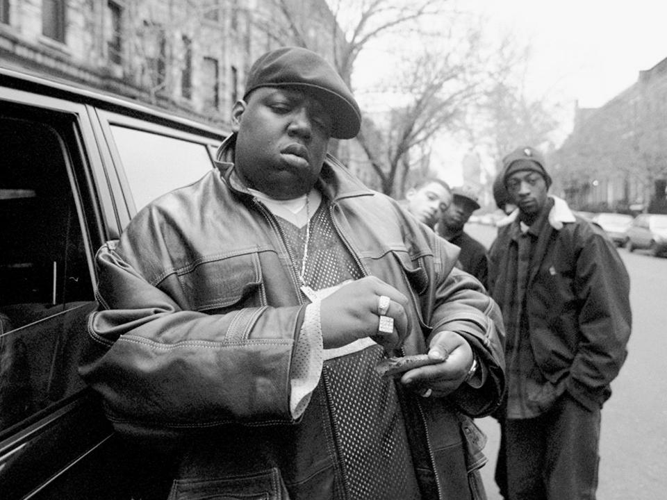 American rapper Notorious B.I.G., aka Biggie Smalls, aka Chris Wallace (1972 - 1997), rolls a cigar outside his mother's house in Brooklyn, New York, 18th January 1995.