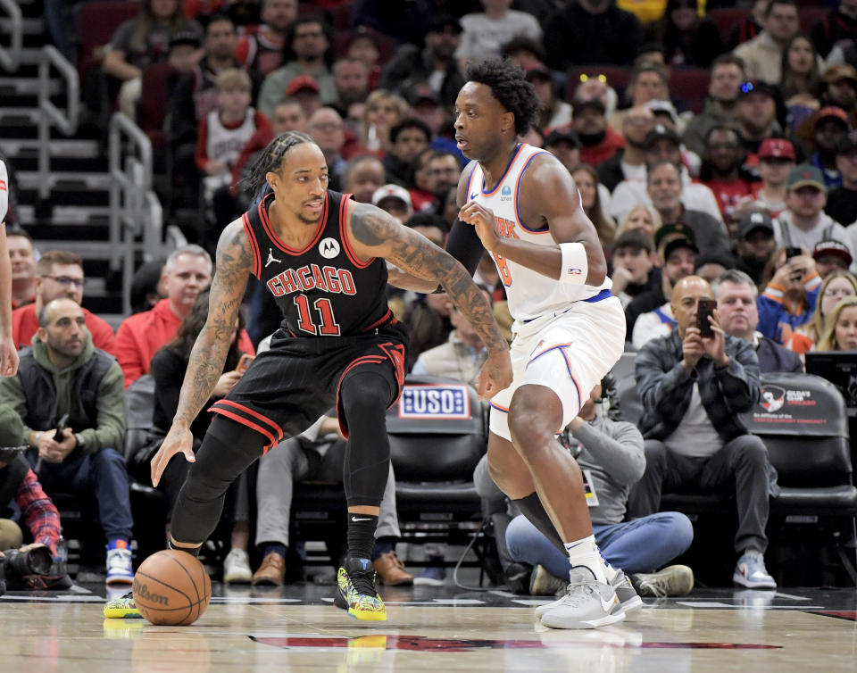 CORRECTS TO OG ANUNOBY, INSTEAD OF DAQUAN JEFFRIES - Chicago Bulls DeMar DeRozan (11) works to move around New York Knicks OG Anunoby (8) during the first quarter of an NBA basketball game in Chicago, Friday, April 5, 2024. (AP Photo/Mark Black)