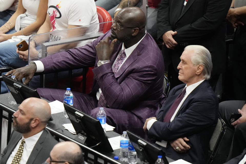 Miami Heat president Pat Riley sits with former player Shaquille O'Neal during Game 3 of the NBA basketball playoffs Eastern Conference finals between the Miami Heat and the Boston Celtics, Sunday, May 21, 2023, in Miami. (AP Photo/Lynne Sladky)