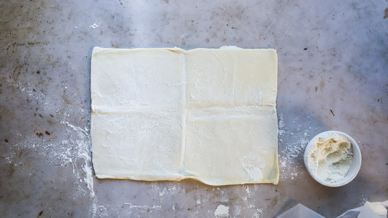 Rolling out raw puff pastry