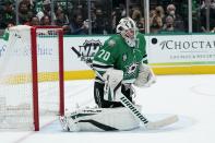 Dallas Stars goaltender Braden Holtby (70) blocks a shot from the Washington Capitals in the second period of an NHL hockey game in Dallas, Friday, Jan. 28, 2022. (AP Photo/Tony Gutierrez)