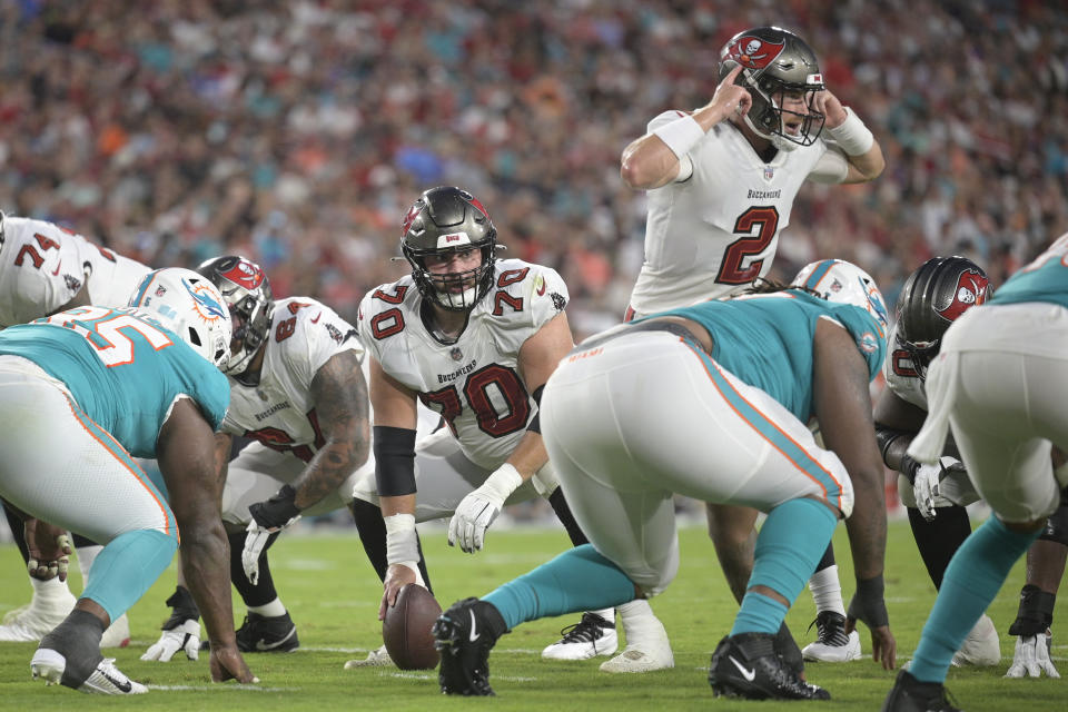 Tampa Bay Buccaneers offensive tackle Robert Hainsey (70) gets ready to snap the ball to quarterback Kyle Trask (2) against the Miami Dolphins during the first half of an NFL preseason football game Saturday, Aug. 13, 2022, in Tampa, Fla. (AP Photo/)