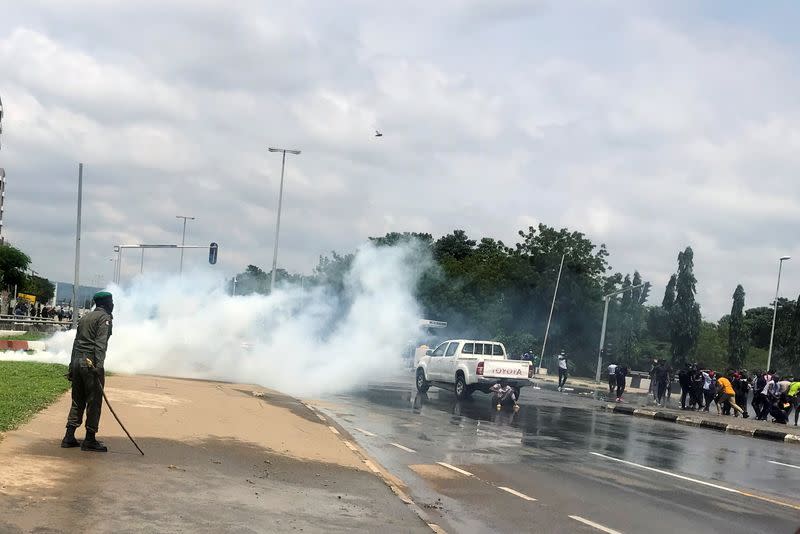 Police fire tear gas to disperse people protesting against alleged brutality by SARS members in Abuja