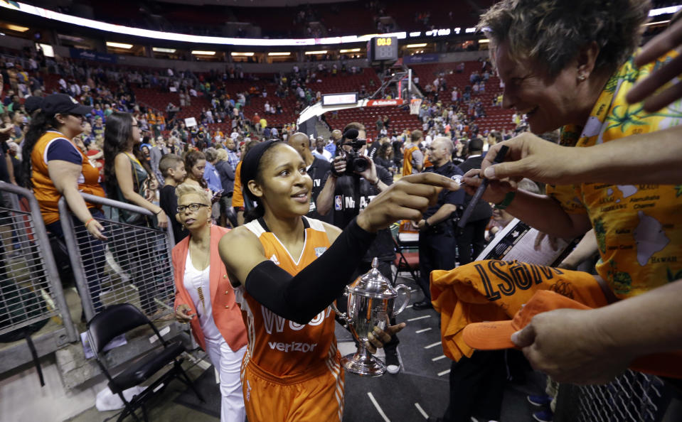 FILE - In this Saturday, July 22, 2017, file photo, Minnesota Lynx's Maya Moore signs autographs after the WNBA All-Star basketball game in Seattle. Moore shocked the basketball world when she stepped away from the WNBA earlier in 2019 before the season began. She’s spent a lot of her time away from the game trying to help a family friend, Jonathan Irons, get his conviction overturned. (AP Photo/Elaine Thompson, File)