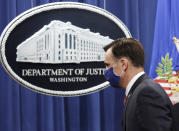 Acting Assistant Attorney General Brian Rabbitt, of the Justice Department's Criminal Division, walks off after speaking at the Justice Department, Thursday, Oct. 22, 2020, in Washington. A subsidiary of Goldman Sachs pleaded guilty on Thursday and agreed to pay more than $2 billion in a foreign corruption probe tied to the Malaysian 1MDB sovereign wealth fund, which was looted of billions of dollars in a corruption scandal. The company, Goldman Sachs Malaysia, entered the plea in federal court in Brooklyn. (Yuri Gripas/The New York Times via AP, Pool)