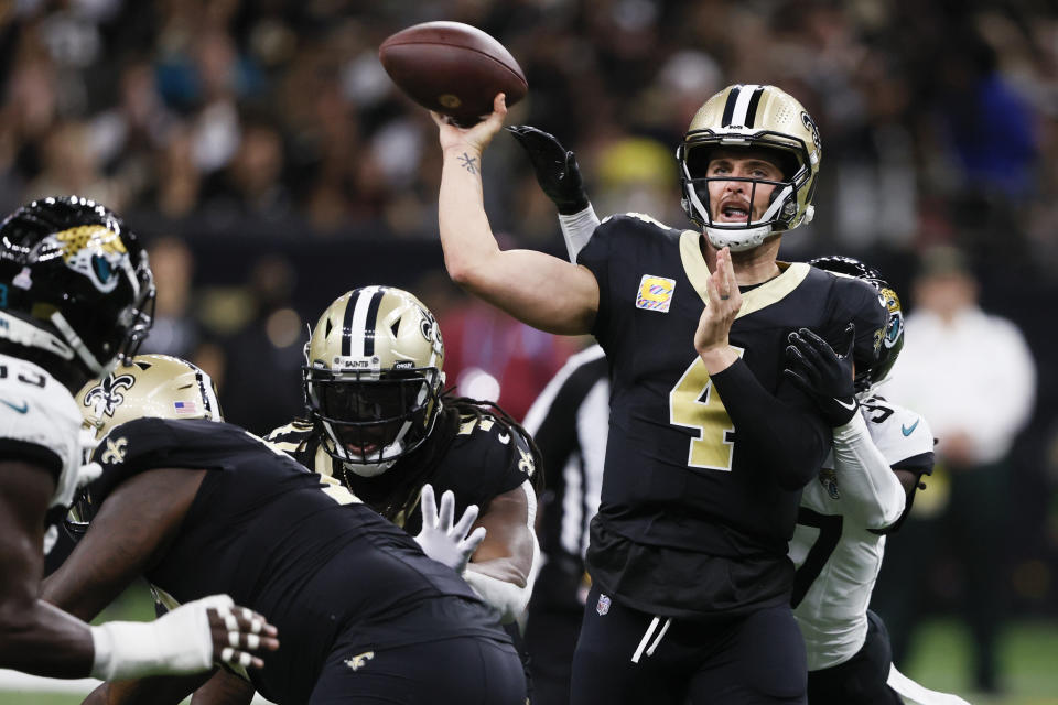 New Orleans Saints quarterback Derek Carr (4) throws a pass as he is pressured by the Jacksonville Jaguars defense in the first half of an NFL football game in New Orleans, Thursday, Oct. 19, 2023. (AP Photo/Butch Dill)