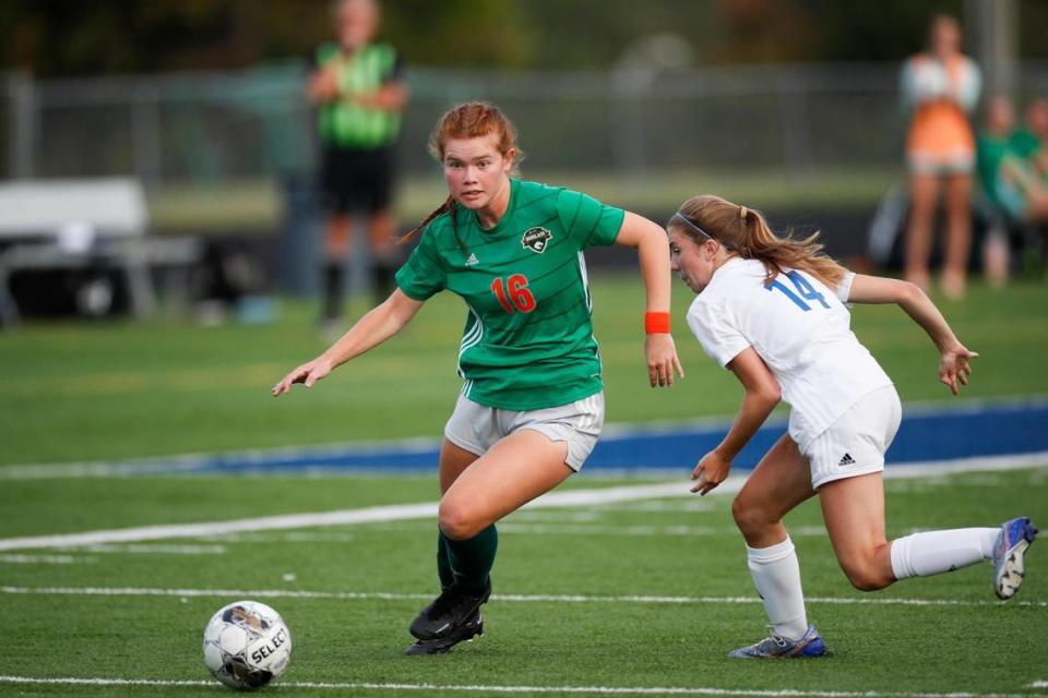 Frederick Douglass’ Haley Flynn (16) moves the ball past Henry Clay’s Claire Nicholas during the 42nd District girls soccer tournament finals on Oct. 4.