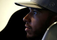 Mercedes' Lewis Hamilton of Britain sits in a driving simulator at a publicity event ahead of the Singapore F1 Grand Prix Night Race in Singapore September 14, 2016. REUTERS/Edgar Su