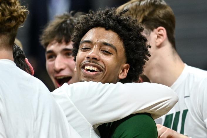 Williamston&#39;s Mason Docks celebrates with teammates after beating Grand Rapids Catholic Central 68-65 to win the Division 2 title on Saturday, March 26, 2022, at the Breslin Center in East Lansing.