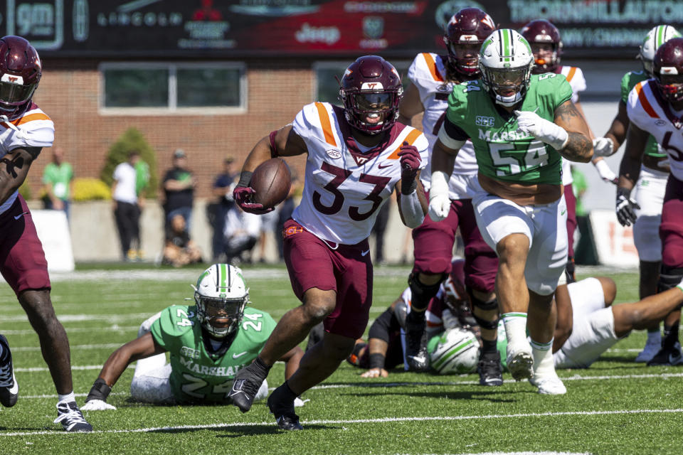Virginia Tech running back Bhayshul Tuten (33) breaks free up the sideline against Marshall during an NCAA college football game, Saturday, Sept. 23, 2023, at Joan C. Edwards Stadium in Huntington, W.Va. (Sholten Singer/The Herald-Dispatch via AP)